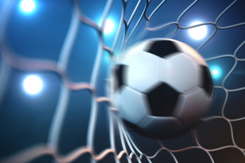 Blurred Football Hitting Goal Net