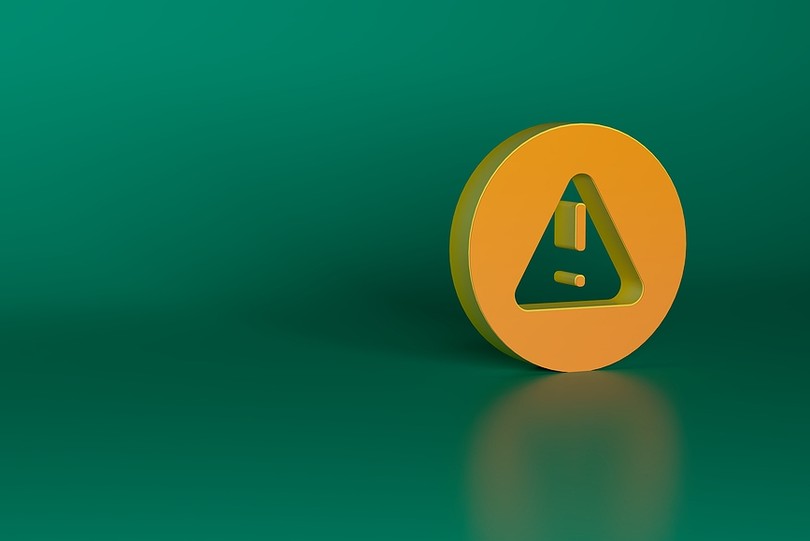 Yellow Warning Triangle Against Green Background