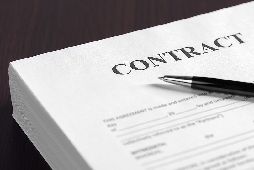 Stack of Contracts on Desk